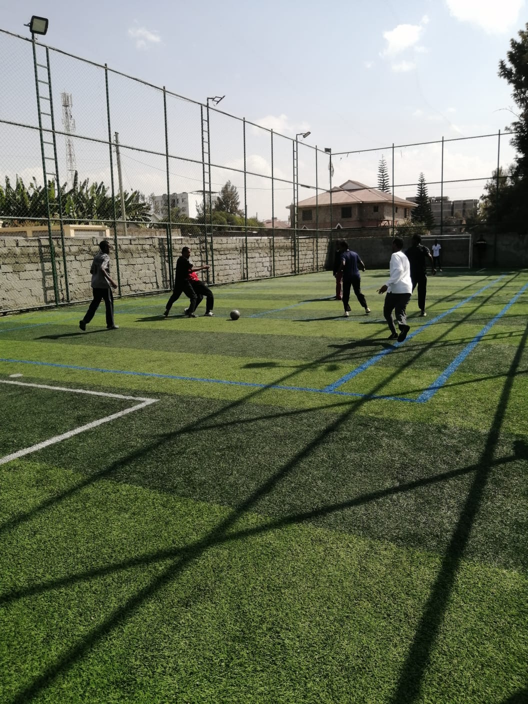 Learners playing football on the astro-turf pitch